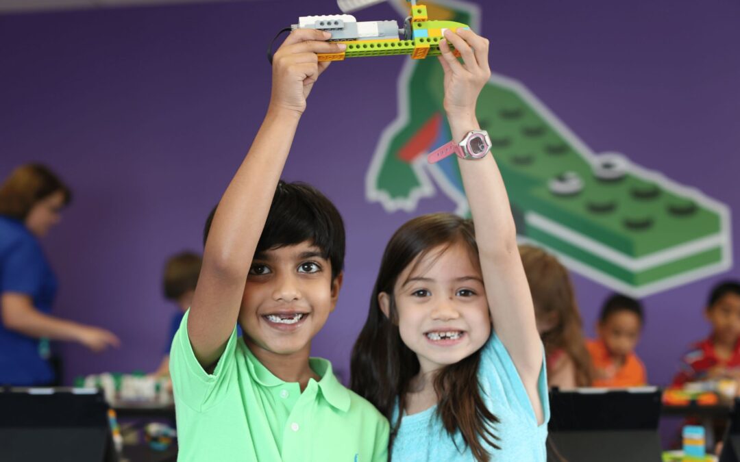 boy and girl holding up a snapology creation