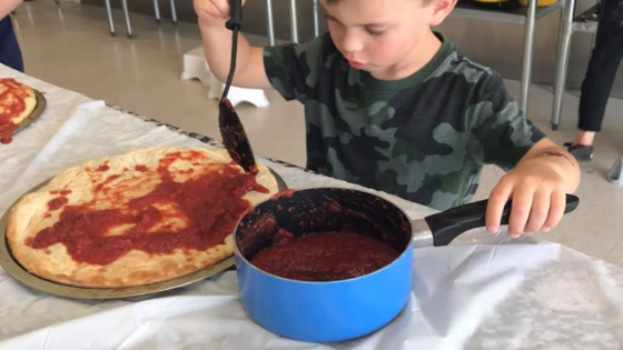 Kid making Pizza