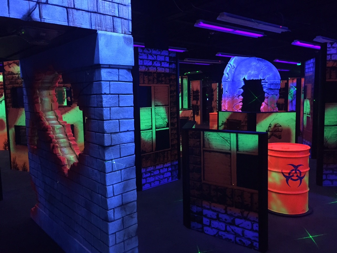 indoor mini golf in the dark with neon lit props