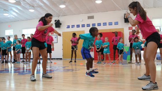 A group of people standing on a basketball courtDescription automatically generated