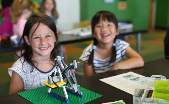 two girls working on a snapology engineering structure