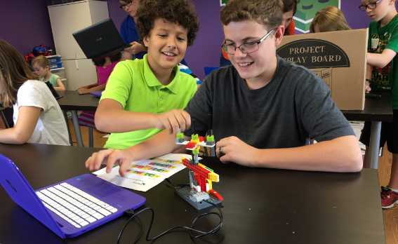 tween boys working on a snapology robot