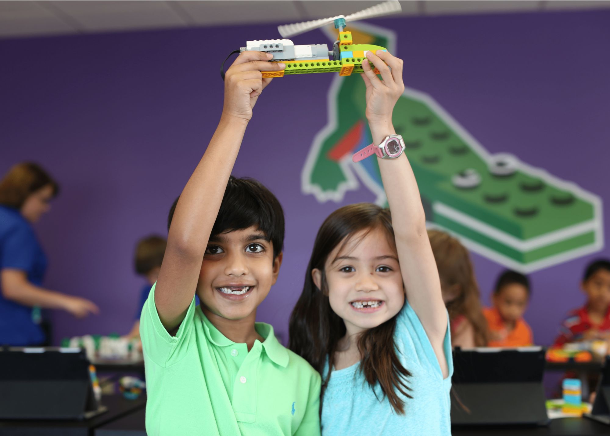 boy and girl holding up a snapology creation