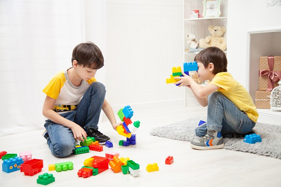 two boys playing using LEGO® bricks