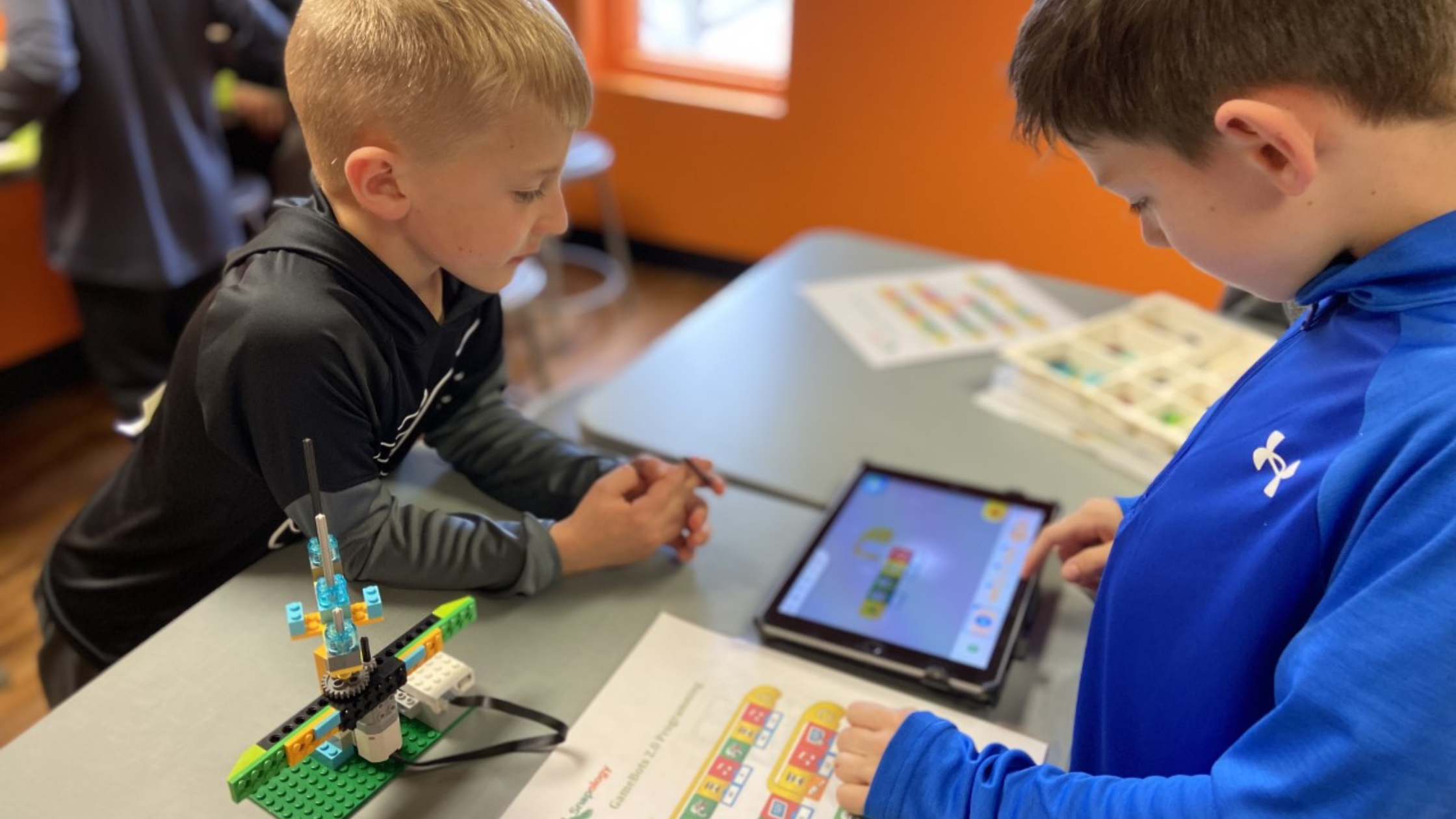 two boys working on a snapology project