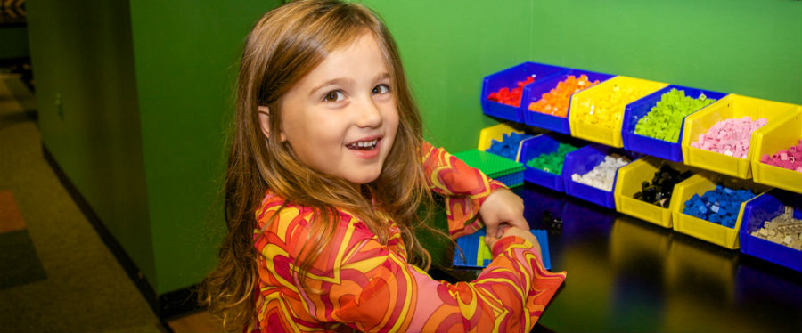 young girl using LEGO® bricks