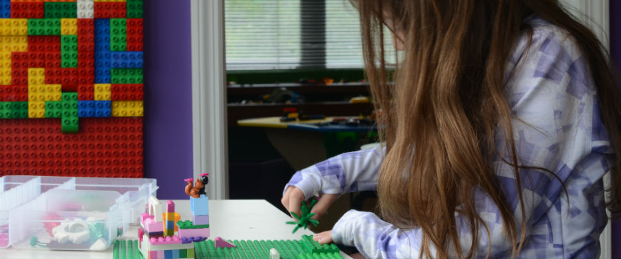 girl building a creation in a snapology class