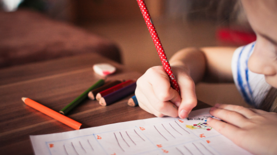 girl completing an activity sheet