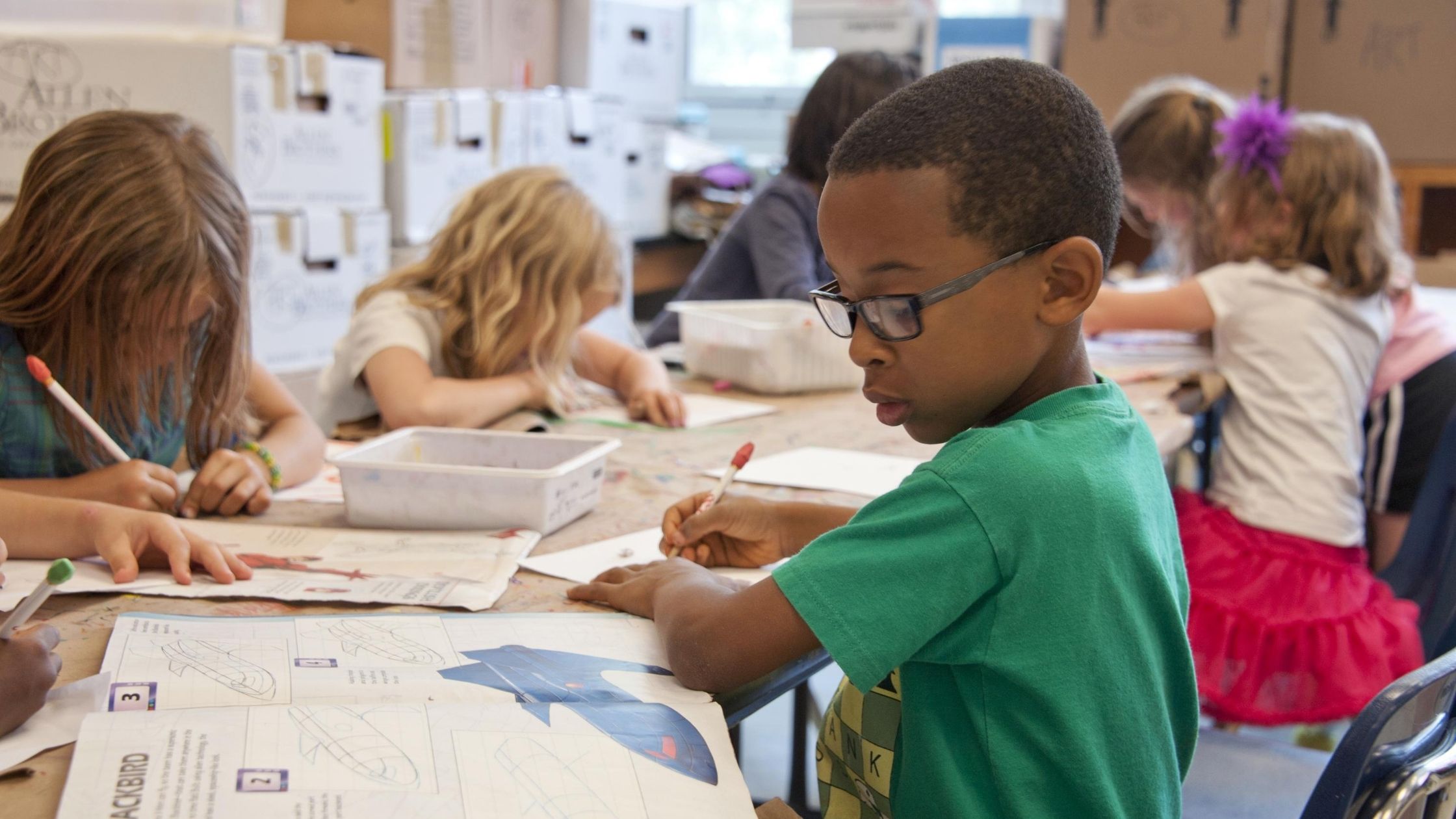 class of children working on their snapology design sketches