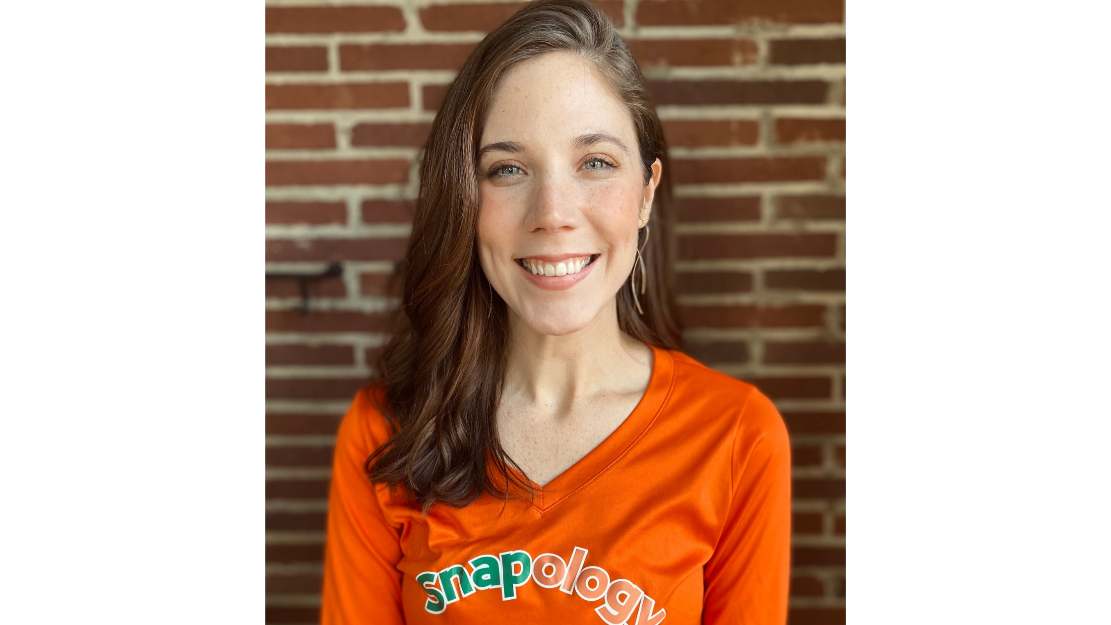 Snapology facilatator smiling, while wearing branded shirt