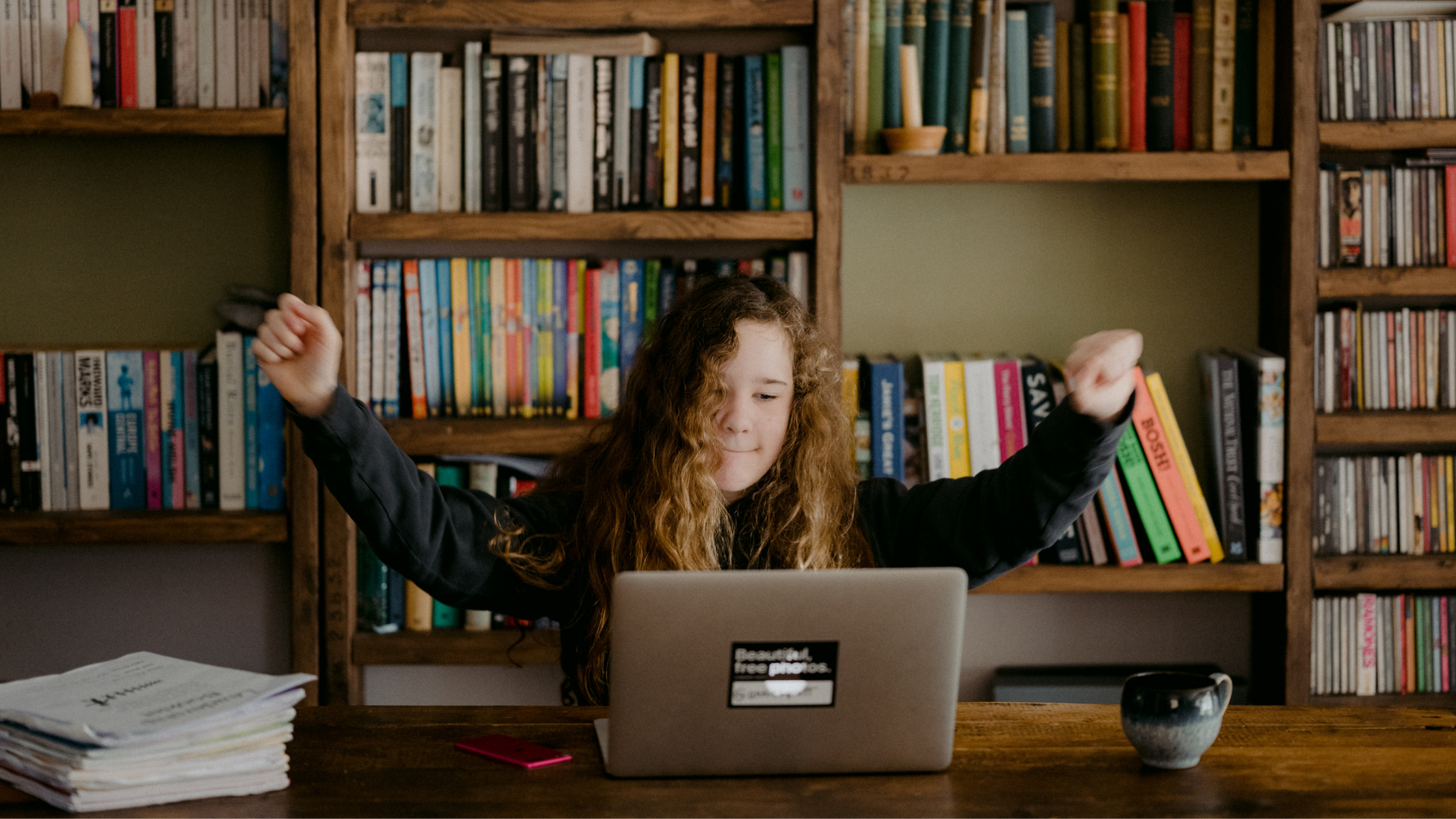 excited girl behind a laptop