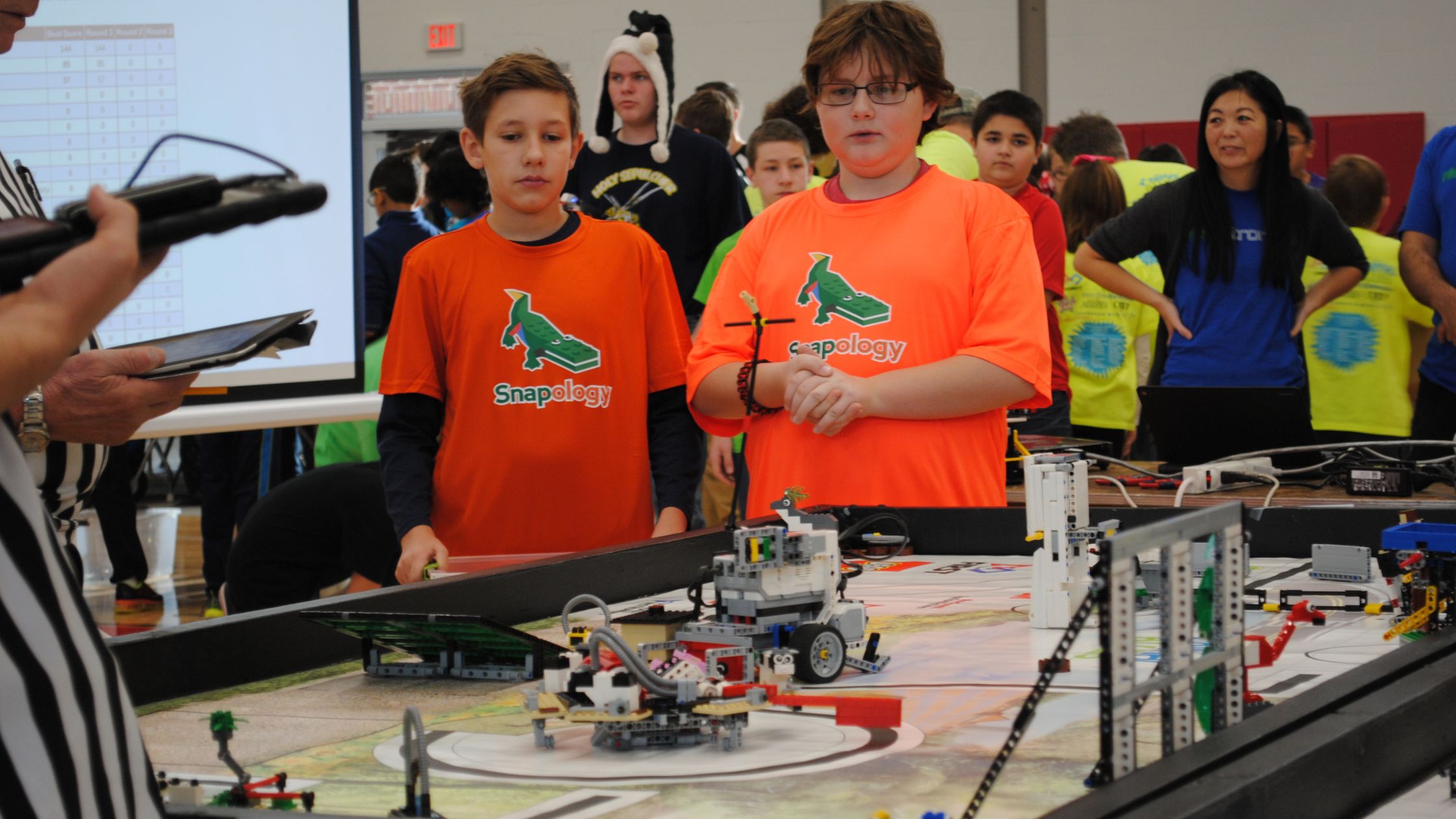 two boys engaged in a snapoloogy robotics challenge