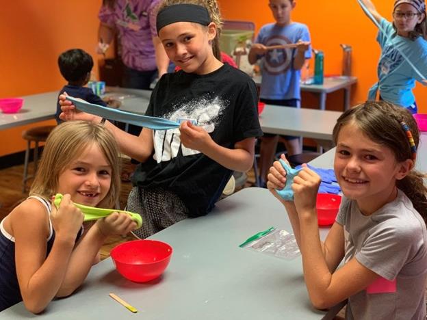 Kids at a homeschool class making DIY slime