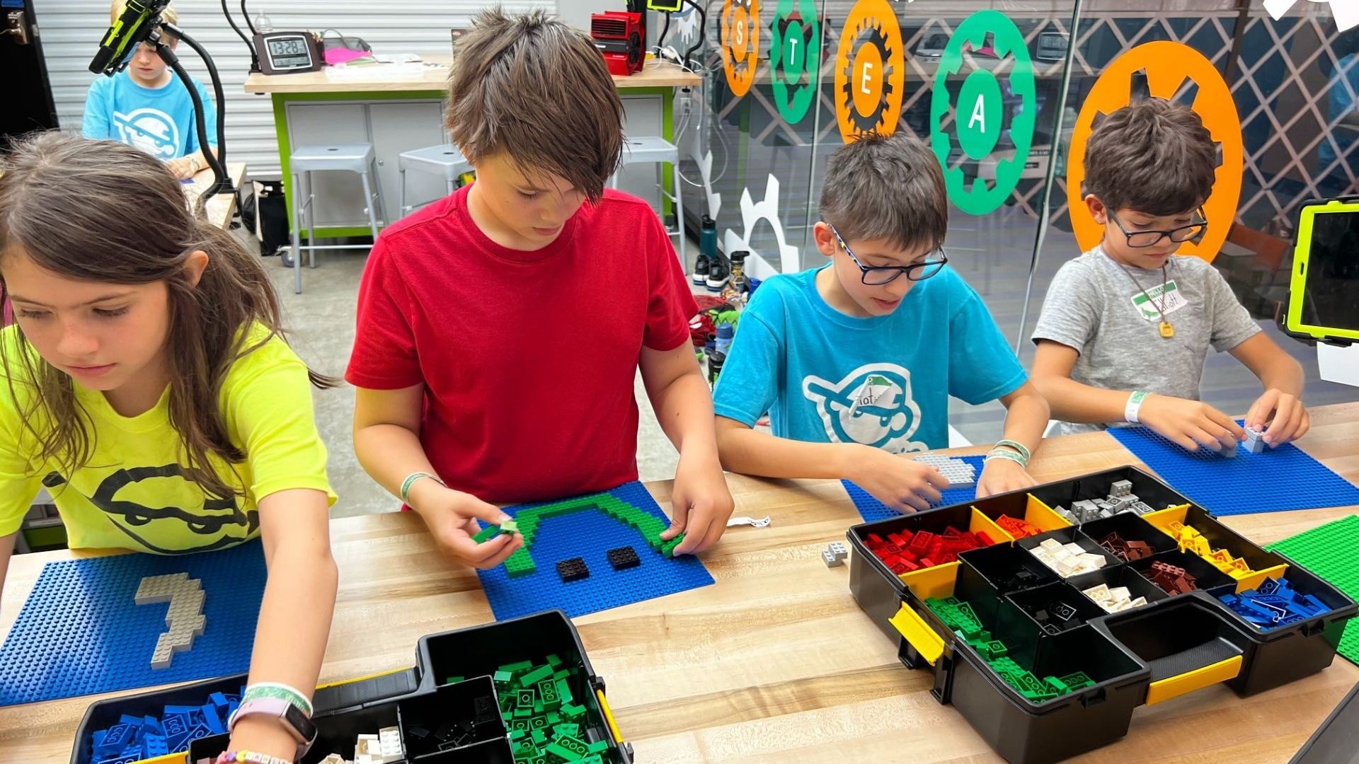 4 kids participating in a STEM lesson at Snapology