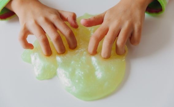 kids hands playing with slime
