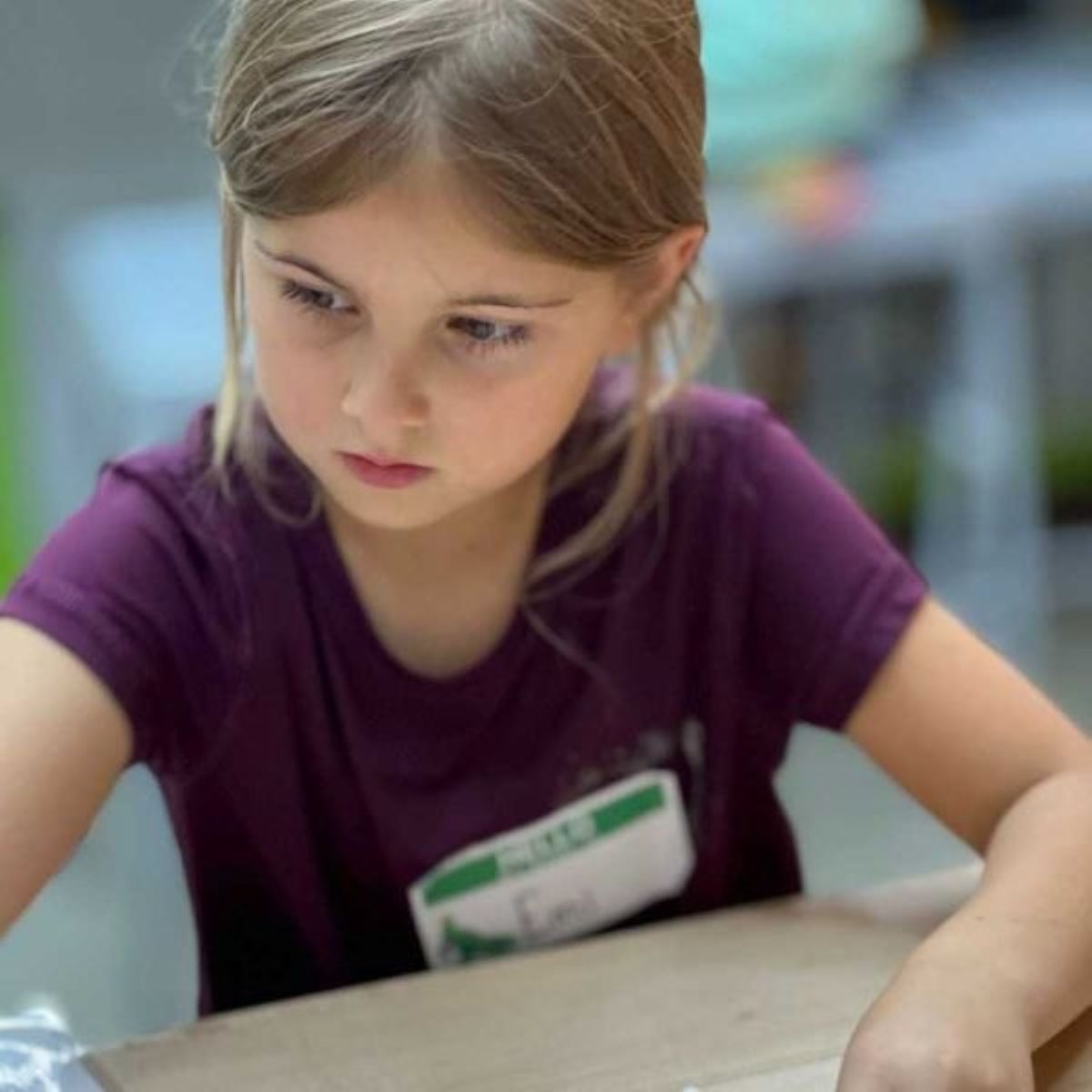 Child concentrating working on Snapology robotics